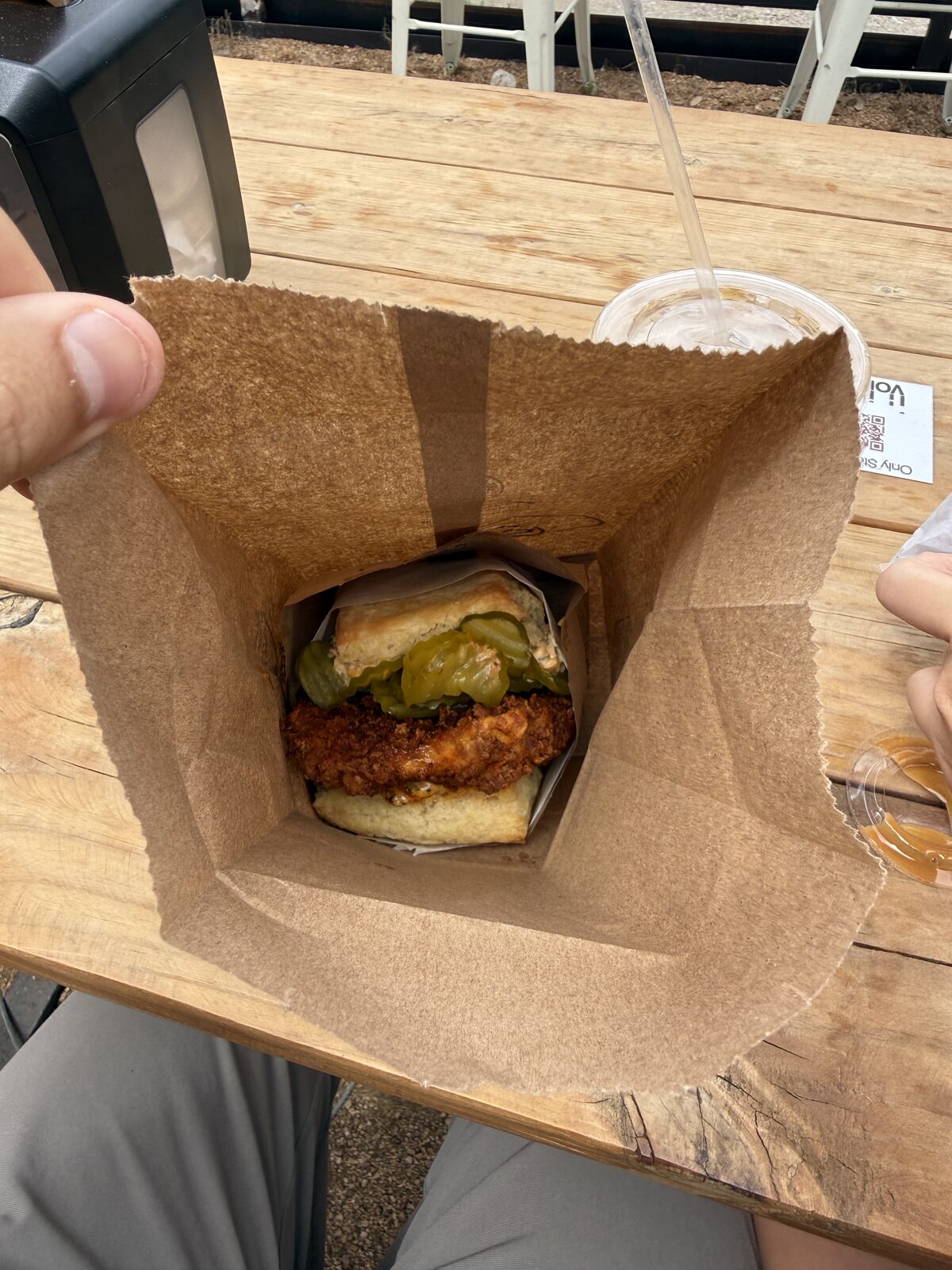 Hot honey chicken biscuit, in the bag, at Bird Bird Biscuit on Manor Road in Austin, Texas