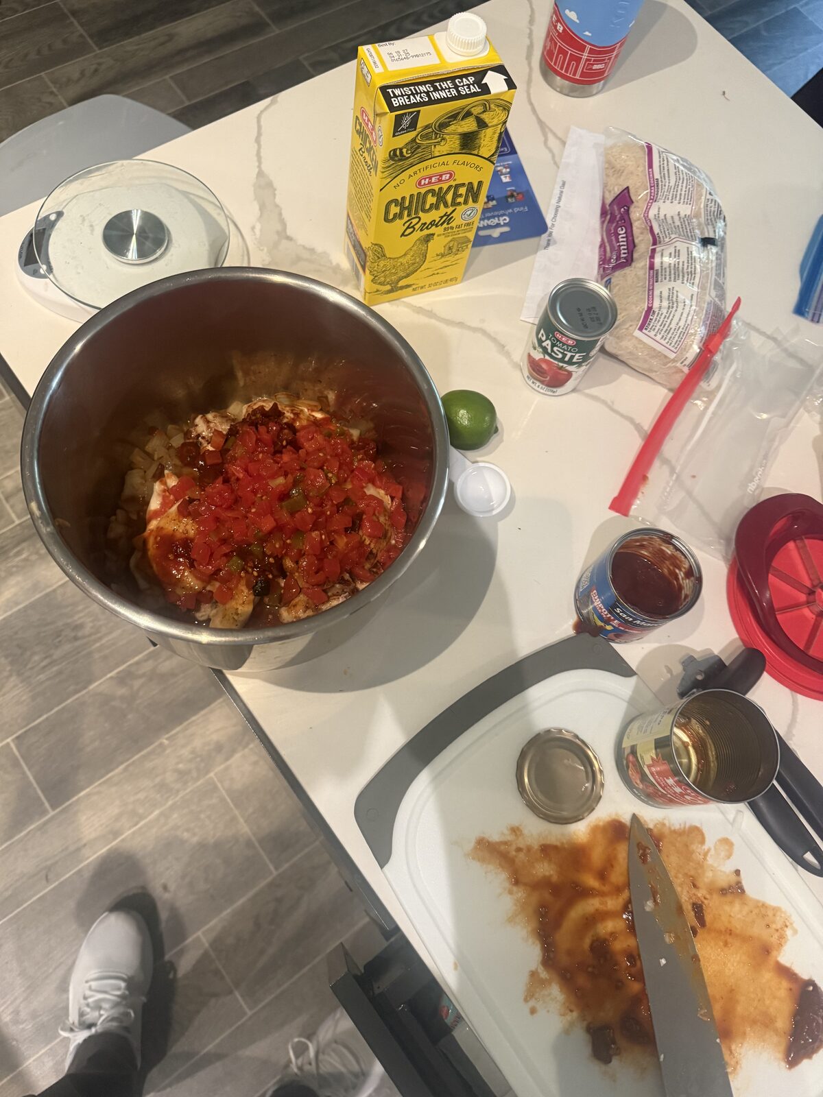 Instant Pot loaded with chicken thighs, fire-roasted tomatoes, chipotles in adobo, and a lime — mise en place for chicken tinga meal prep
