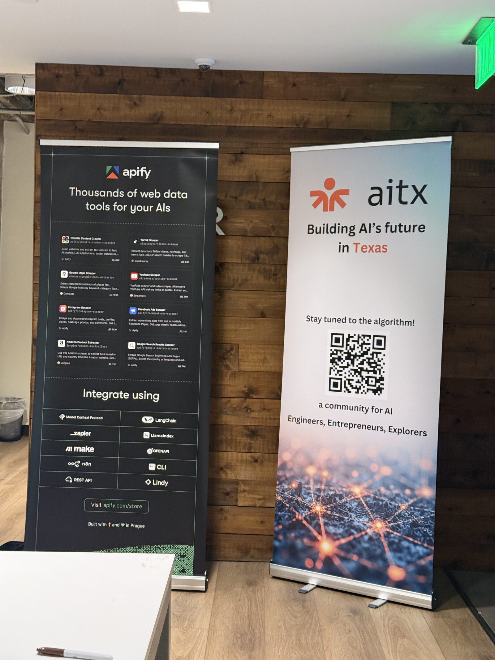 Apify and AITX banners side by side in the venue